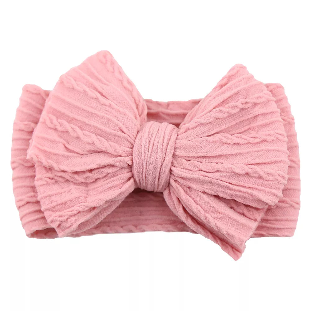 Displayed collection of 20 baby cable bow headbands, perfect for everyday wear