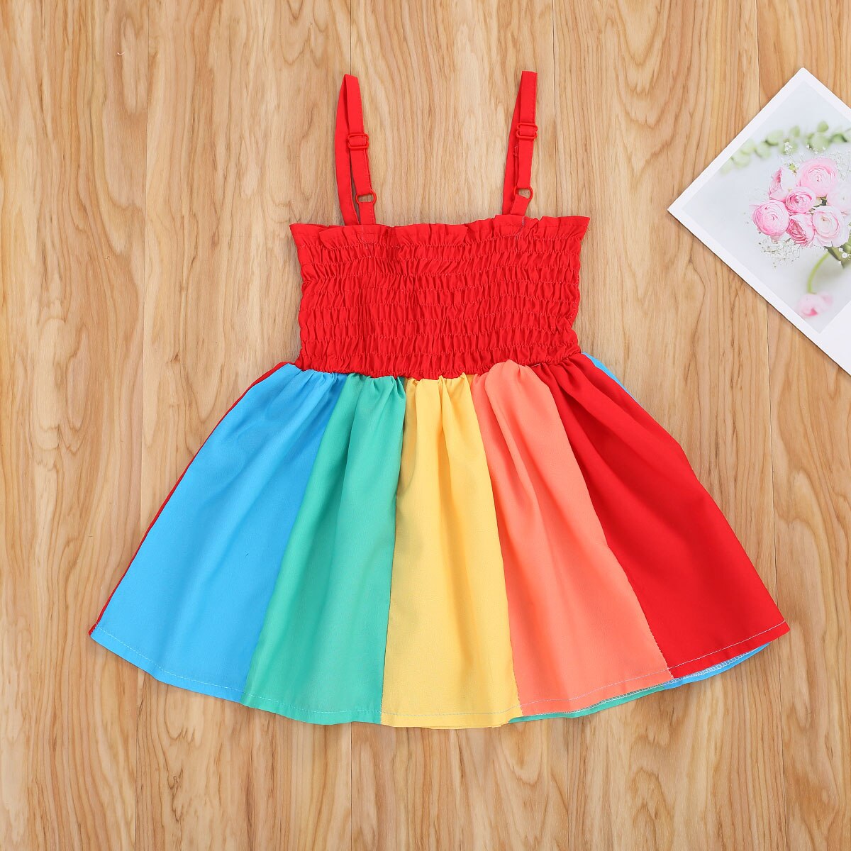 Stylish girls' rainbow summer dress for children, featuring colorful straps and a breathable cotton blend