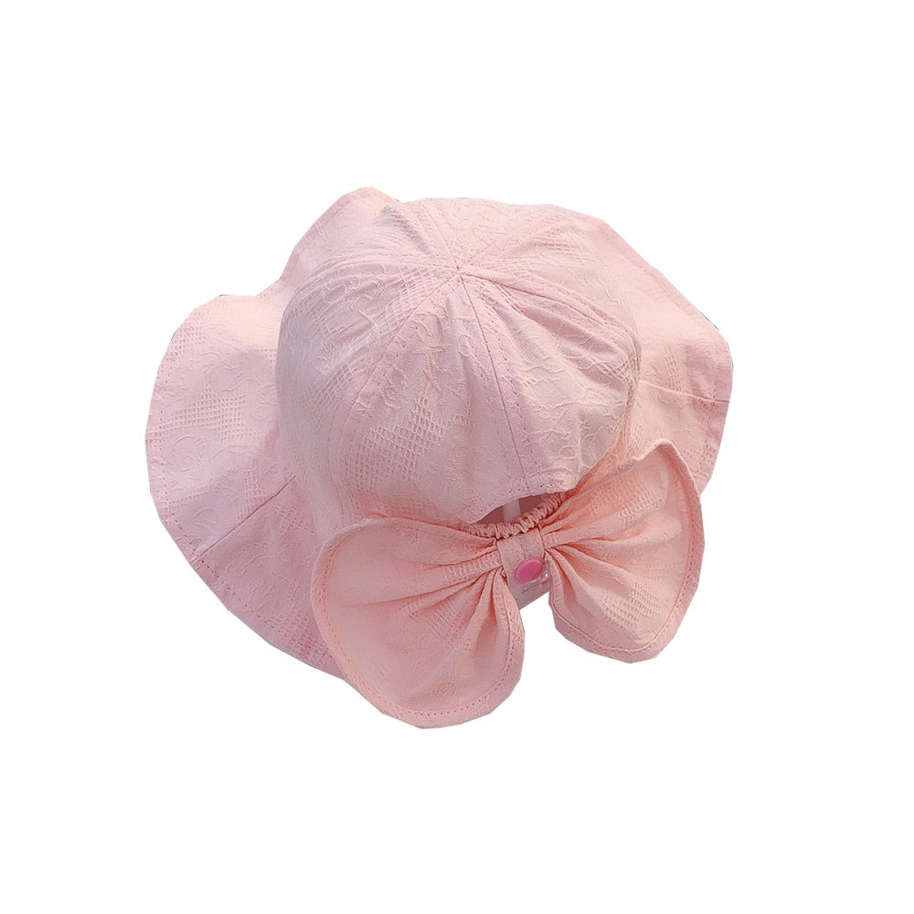 Versatile pink cotton bucket hat for children, providing sun protection for spring and summer
