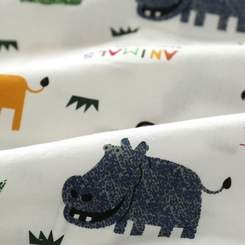 Detailed shot of animal print texture on a baby boy's romper with attached suspender shorts