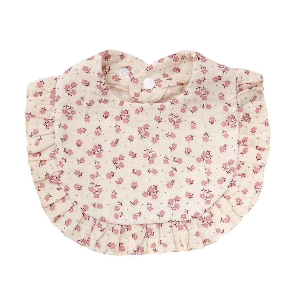 Close-up of the adjustable snap on a baby cotton flower print bib, highlighting its functionality.