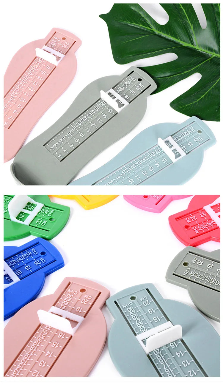 White plastic baby foot measurement gauge tool on a clean, light surface