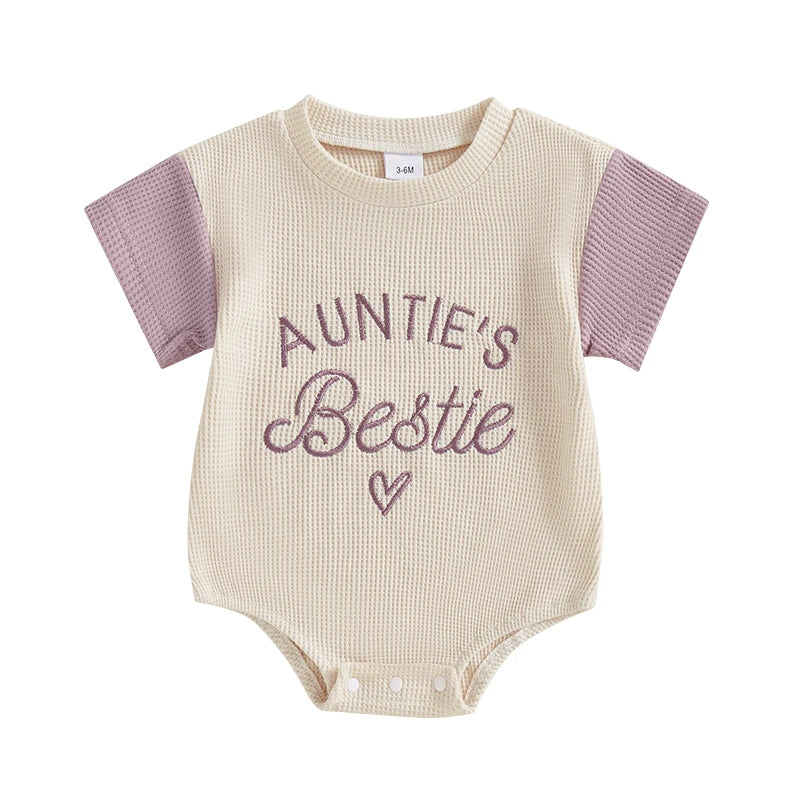 Assorted pink and purple waffle knit baby rompers with embroidery, short sleeve jumpsuits for summer wear.