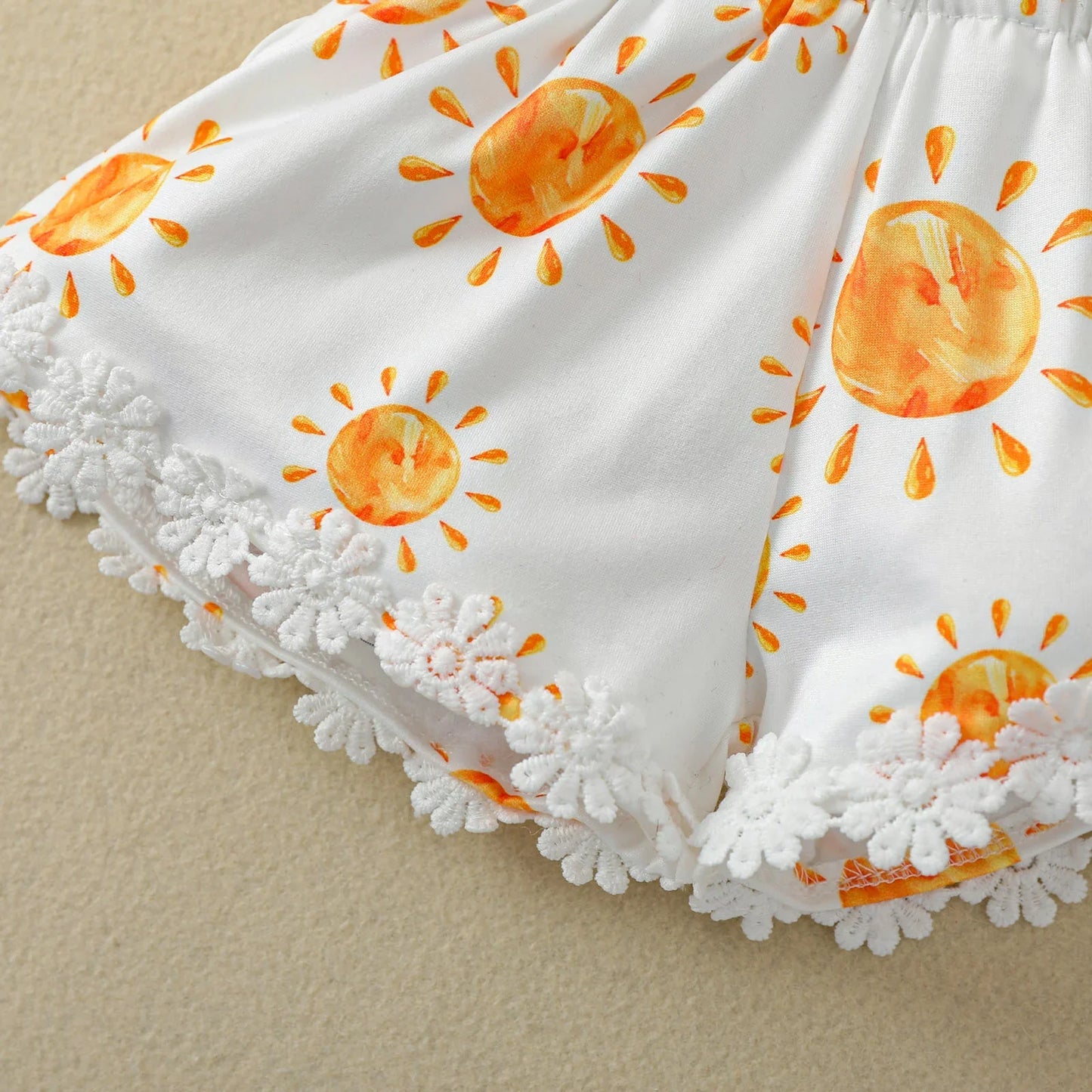 Sleeveless baby girl romper with all-over sun print, sweet and stylish newborn clothes