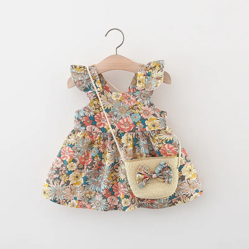 Stylish baby girl's vintage floral summer dress, made from soft cotton, complete with a straw bag.
