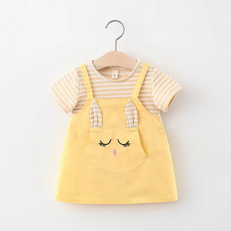 Studio shot of a baby girl's striped princess dress with a delightful cartoon cat design.