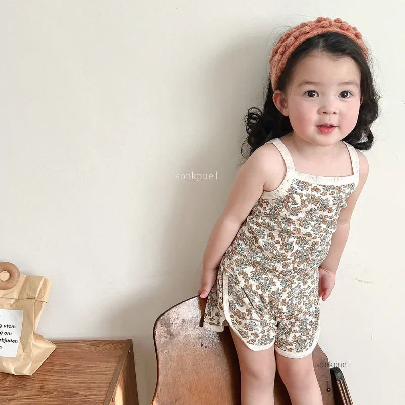 Baby girl's summer playwear cotton outfit with a patterned camisole and coordinating shorts.