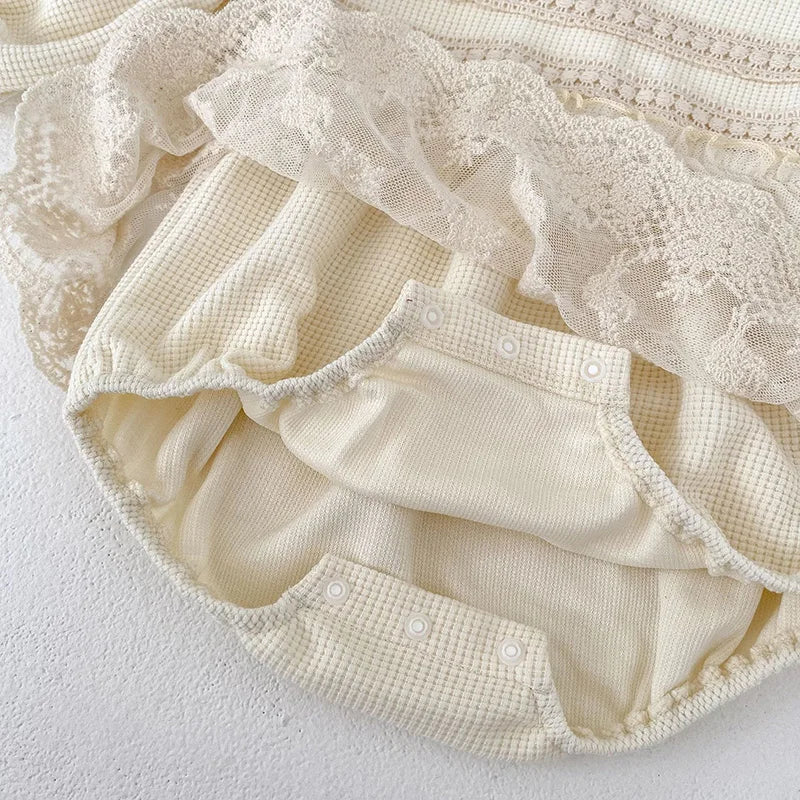Fashionable pink waffle knit infant bodysuit for girls, with puff sleeves and delicate lace.