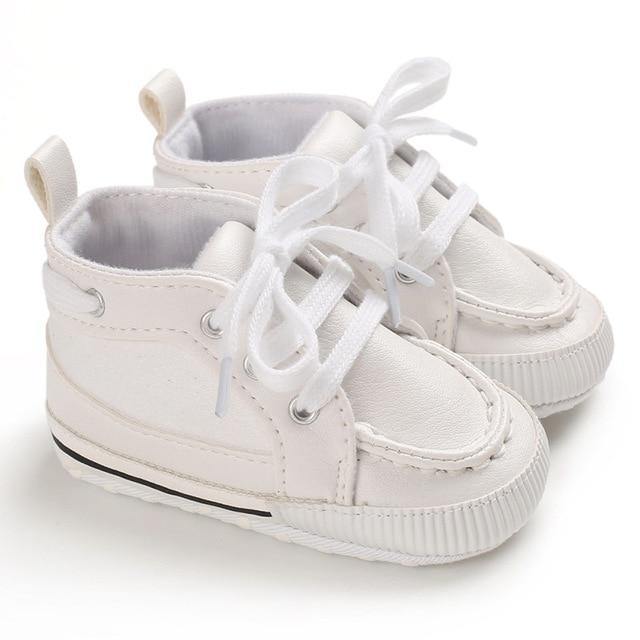 Toddler ankle boots made of supple leather with a soft sole and adjustable lace-up fit, perfect for walkers.