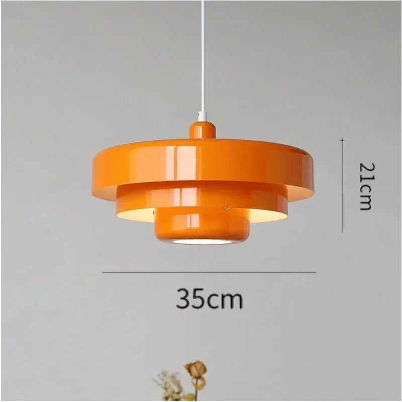 Bauhaus Metal LED Pendant Light in vibrant orange, green, and white with three-tier design illuminating a modern room.