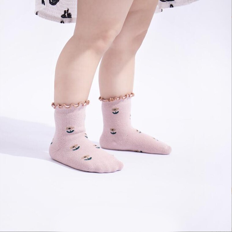 Collection of colorful children's floral ankle socks, a stylish and breathable accessory for kids fashion.
