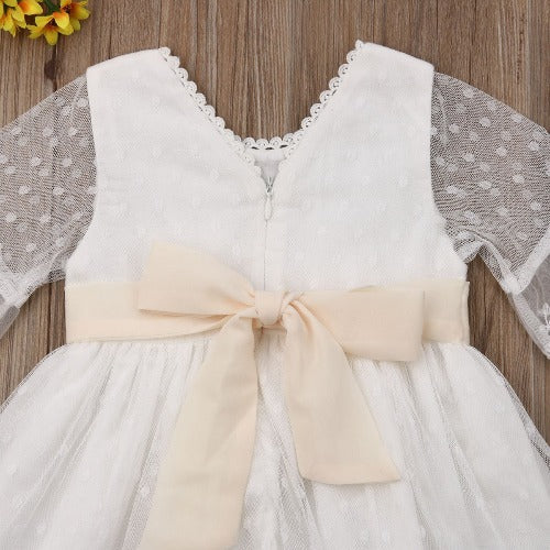 White long sleeve infant dress featuring delicate floral lace, ideal for baby girl fashion.