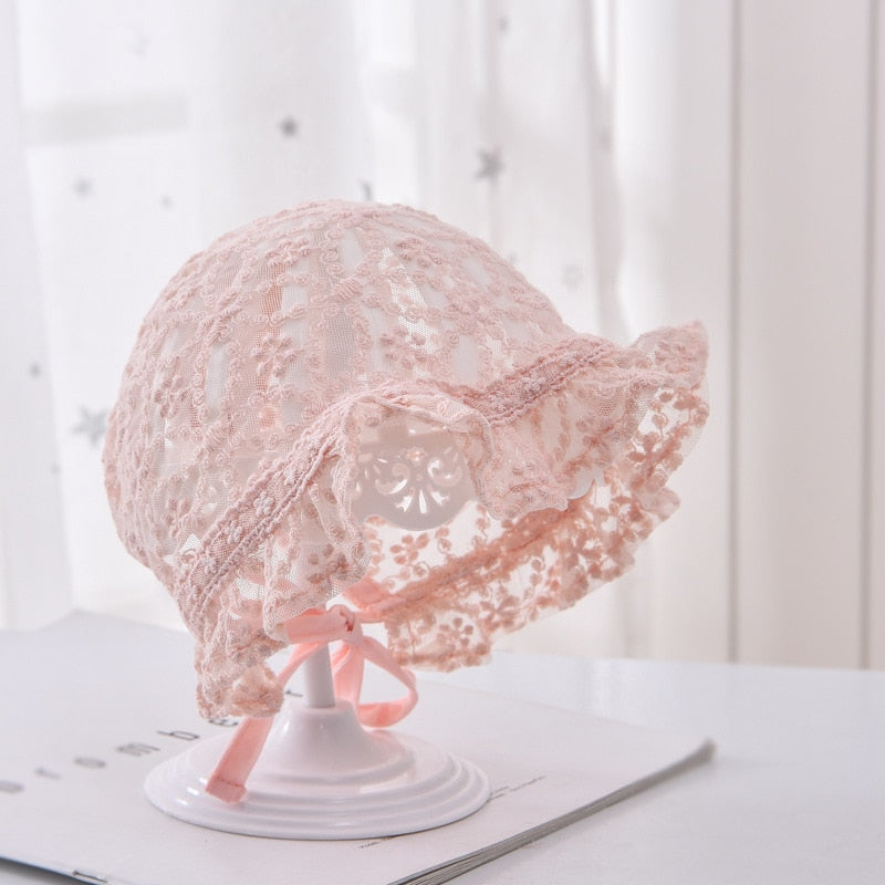 Vintage-style white lace flower bonnet for baby girls, perfect for newborn photography.