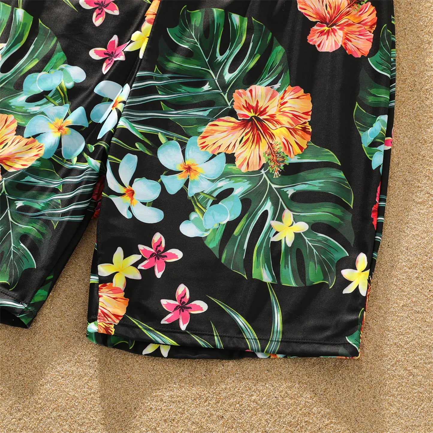 Group of family members wearing matching coconut print beachwear enjoying a sunny summer day.