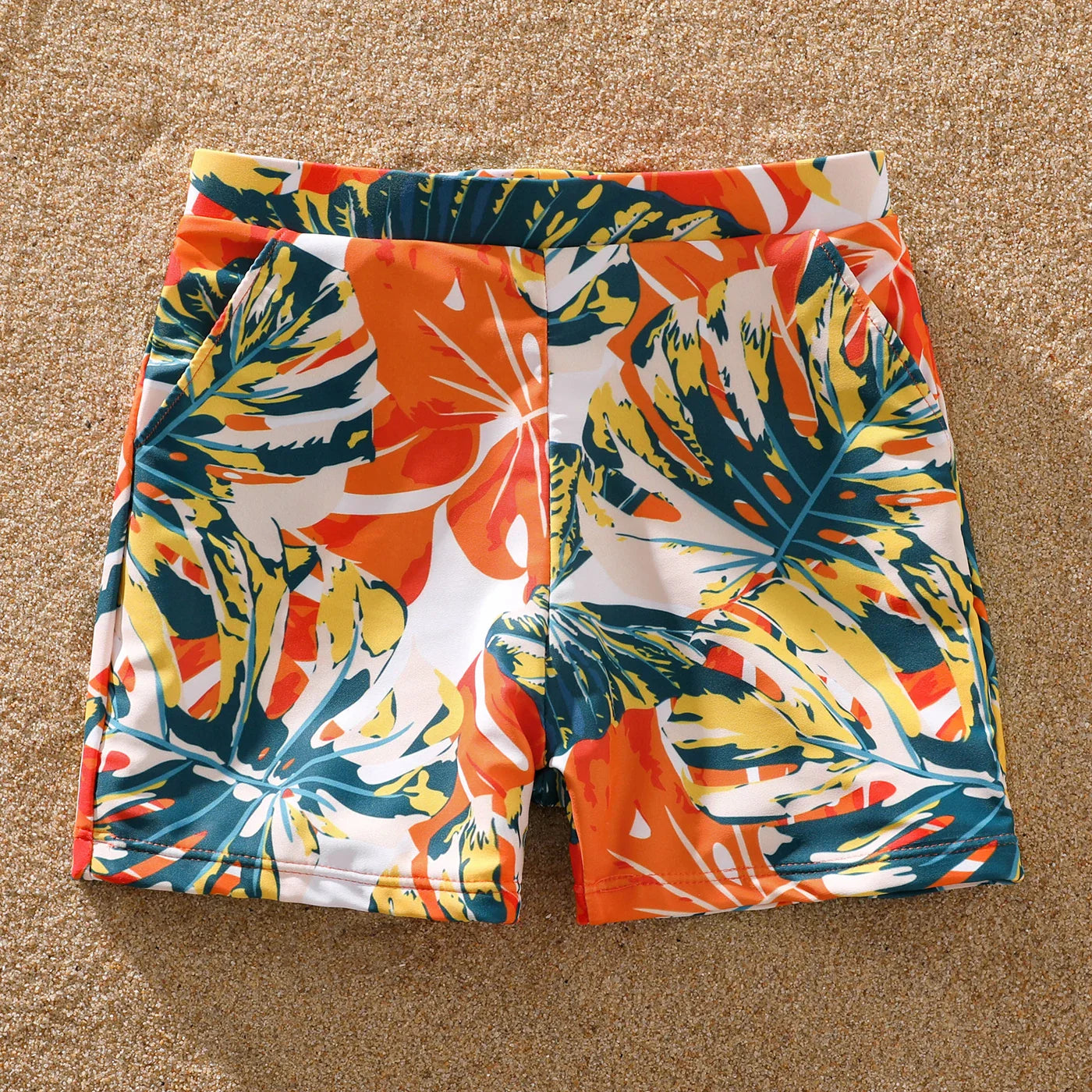 Get ready for summer with this family matching orange tropical swimwear set.