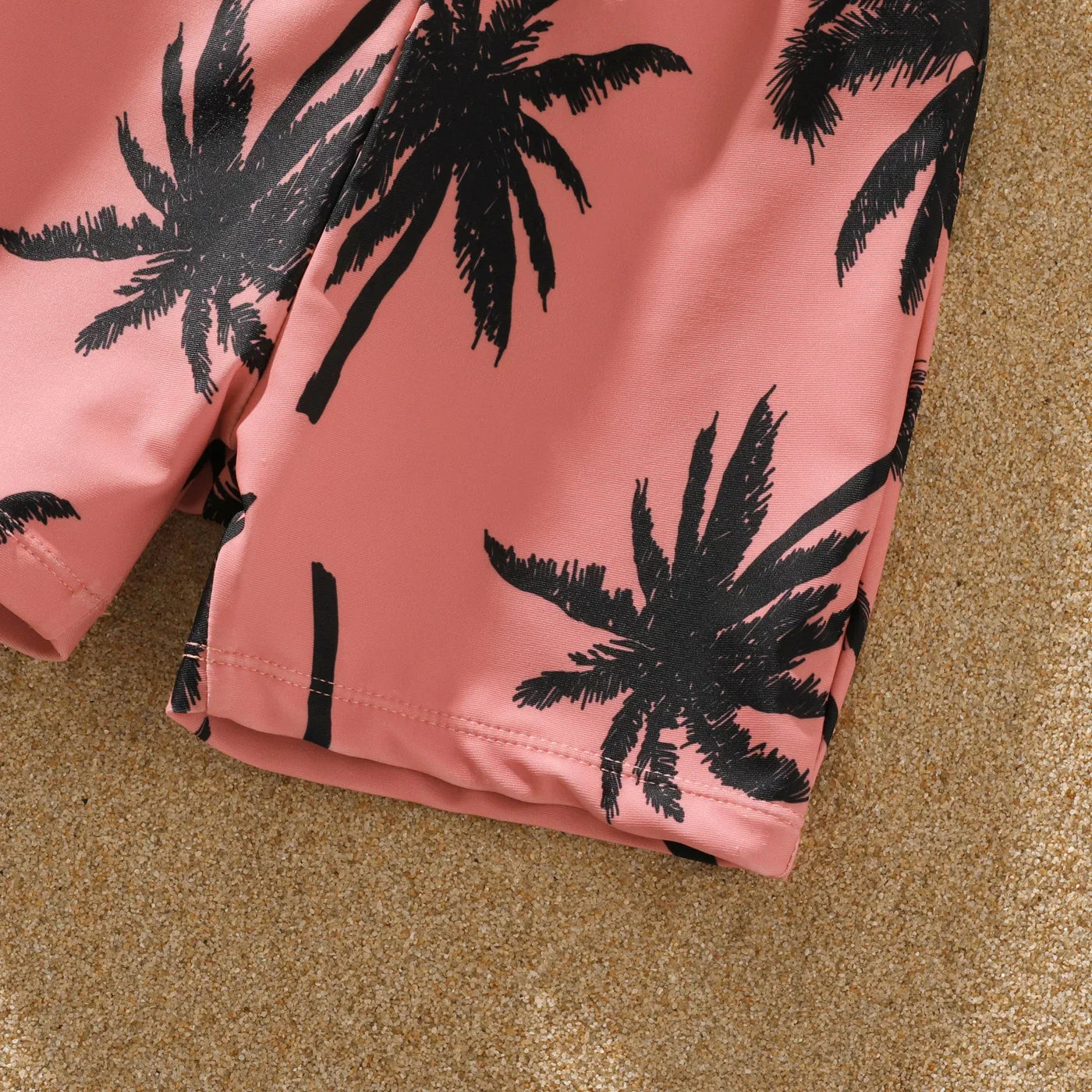 Stylish pink family bikini and shorts set with tropical coconut tree pattern