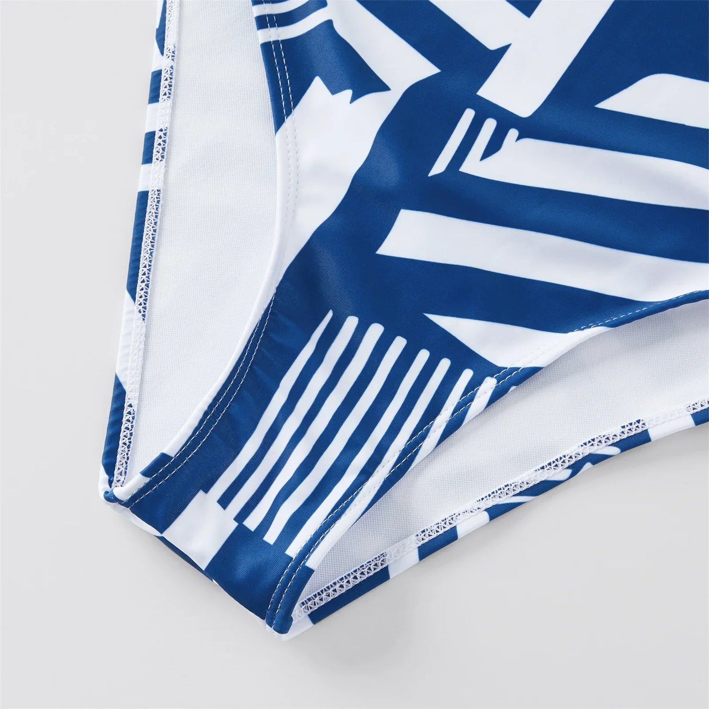 Collection of family matching ruffled one-piece swimsuits and men's swim trunks for holiday wear
