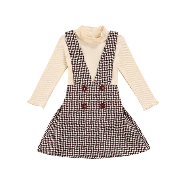 Kids' fall clothing: a fashionable turtleneck and plaid pinafore skirt set, perfect for autumn