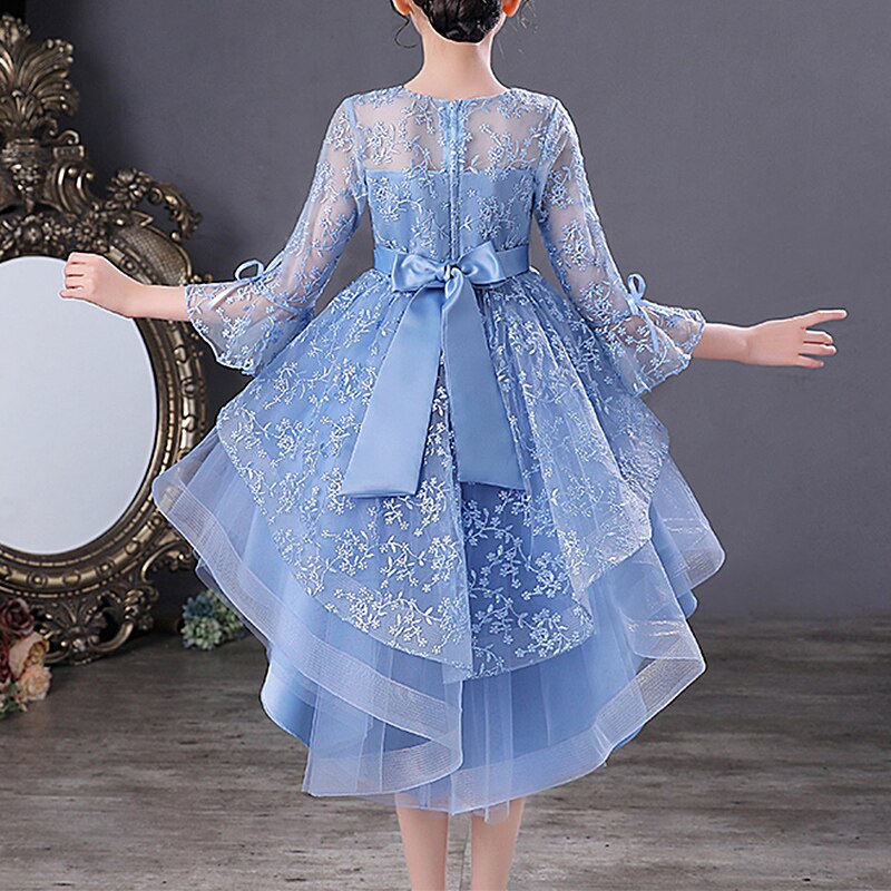 Detailed back view of a girls' jacquard mesh bow party dress, showcasing the dovetail design.