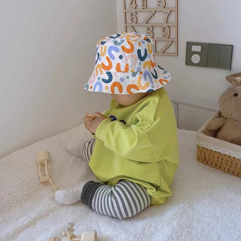 Fashionable beige toddler hat, double-sided and reversible for ultimate sun protection and style.