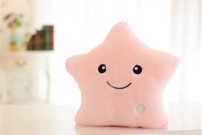 White luminous star plush pillow, a serene night light and soft comfort item for children.