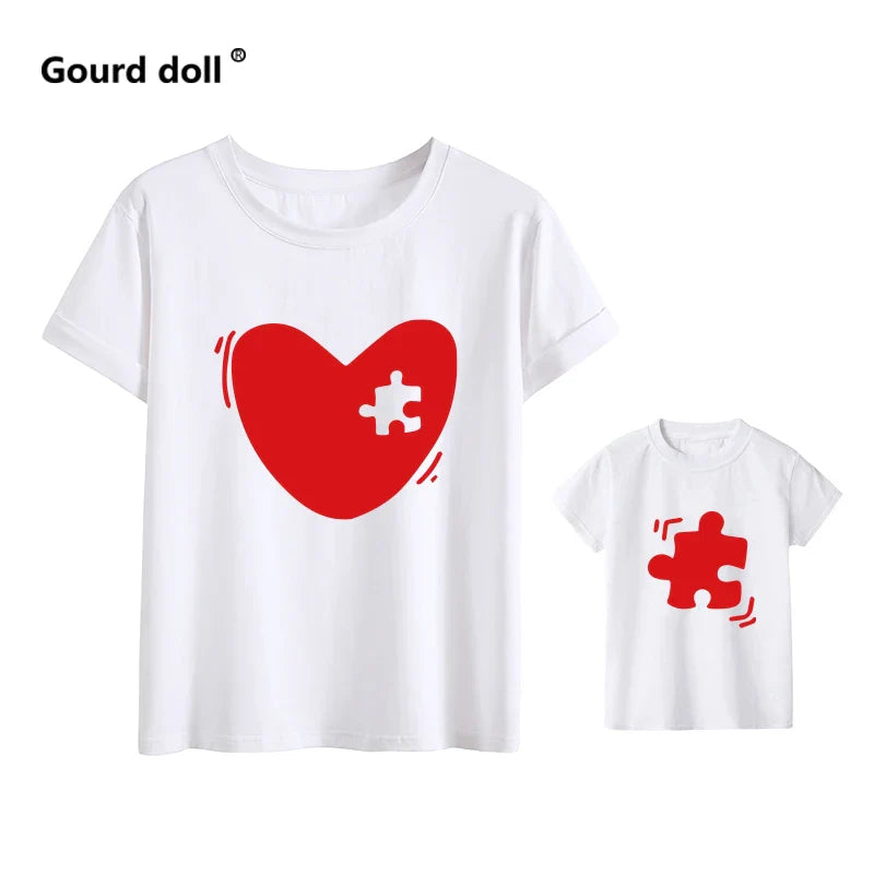 Flat lay of women's and kid's matching family print t-shirts, ready for summer outings