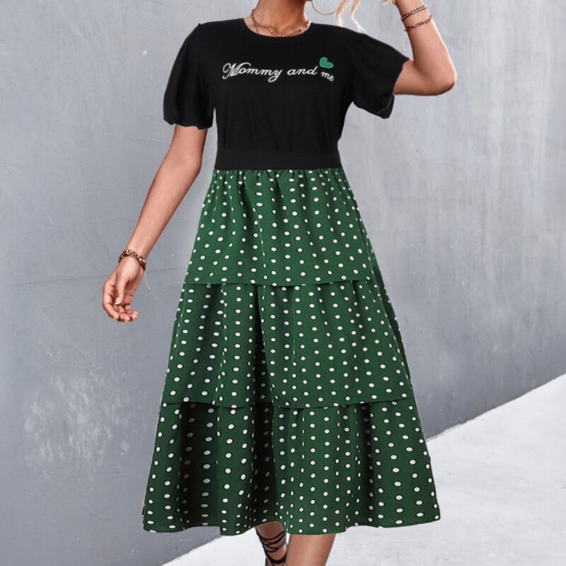 Coordinating family matching clothes: White letter print tops and black polka dot skirts for a mother and her child.