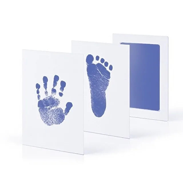 A parent smiling while using the handprint kit on their baby, creating a joyful, lasting baby keepsake.