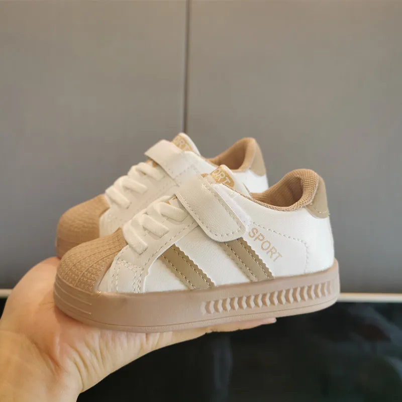 Top-down view of white children's fashion-forward anti-slip sneakers, designed for comfort and active, everyday wear.