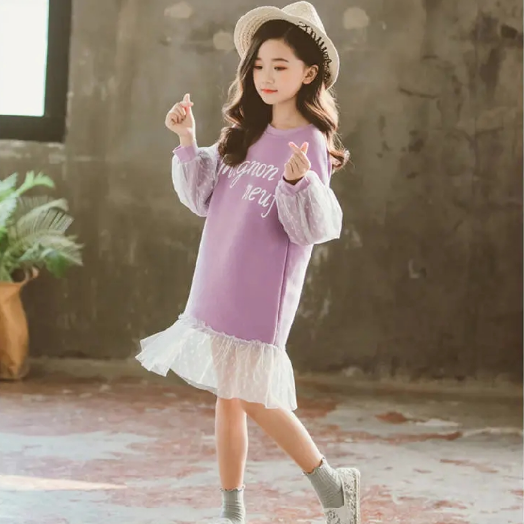 Close-up of pink polka dot and lace fabric on a girl's knee-length dress, cotton material, youth