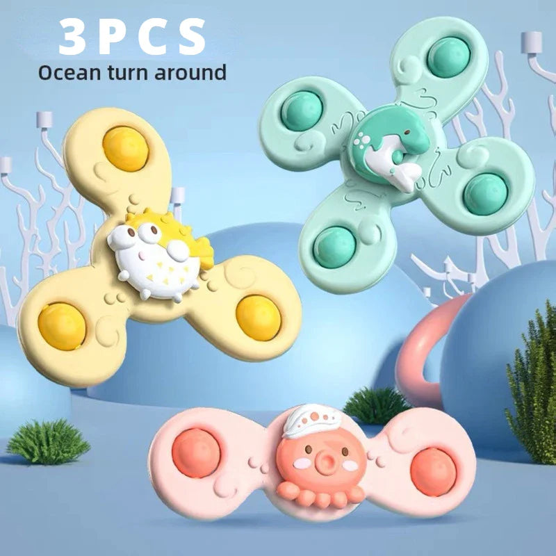 Happy baby reaching for a spinning suction toy, part of a fun and safe bath toy collection