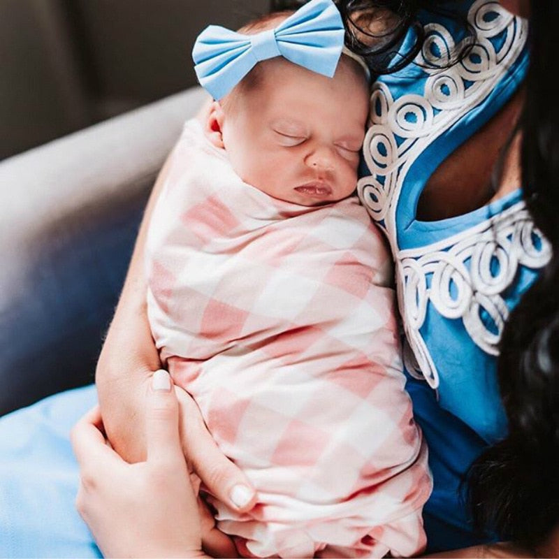 Essential newborn baby plaid swaddle and hat set for a comfortable and stylish infant.