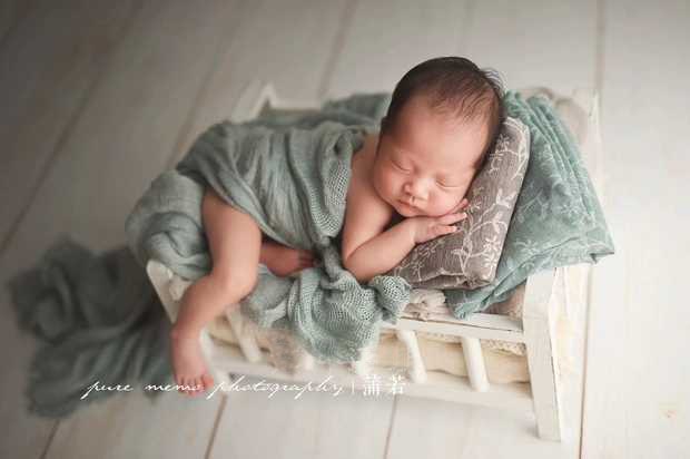 Handmade knit baby swaddle blanket in a neutral tone, ideal for newborn photo shoots and cozy infants.
