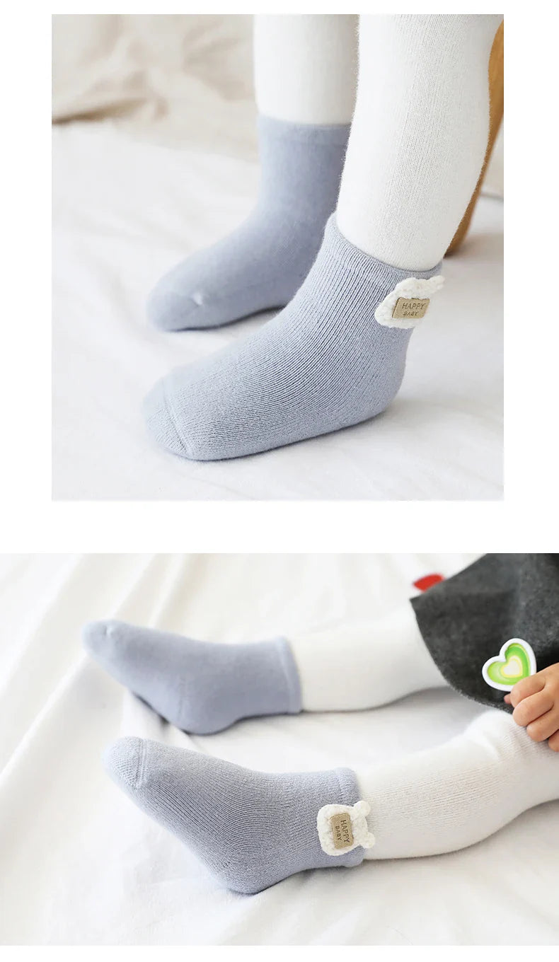 Toddler winter socks with vibrant animal designs, ensuring warmth and cuteness for baby's feet.