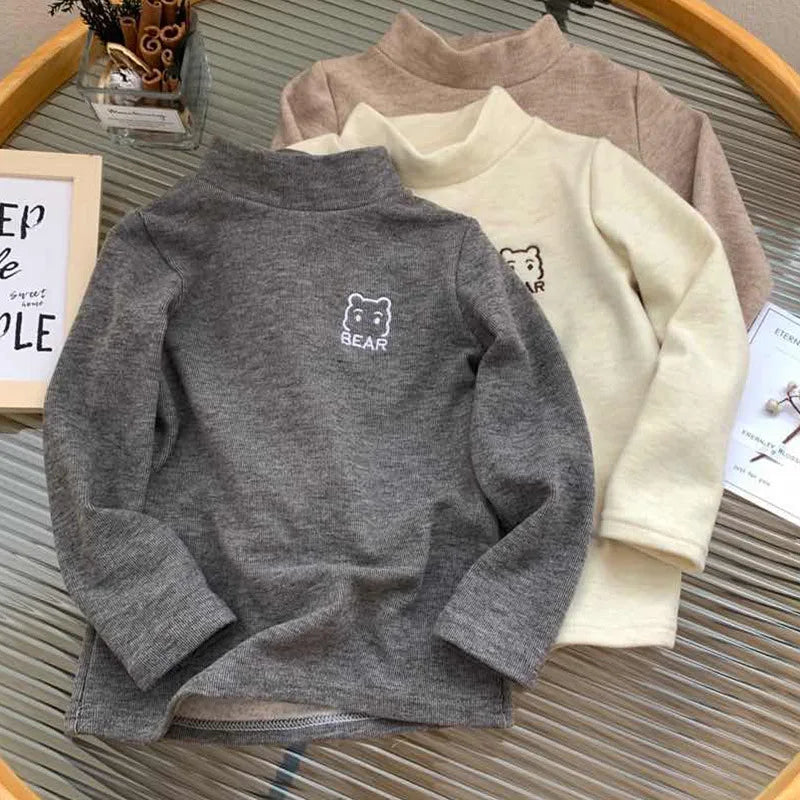 Detail of the bear design on a toddler fleece turtleneck shirt, children's fashion