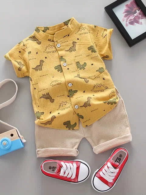 Lay flat of a blue dinosaur t-shirt and coordinating shorts, a cute boys' summer outfit