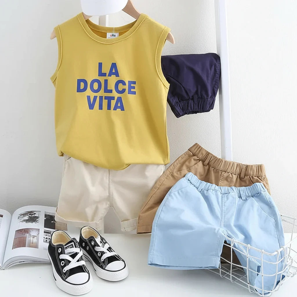 Smiling boy in green breathable cotton shorts, enjoying summer fun, comfortable playwear.