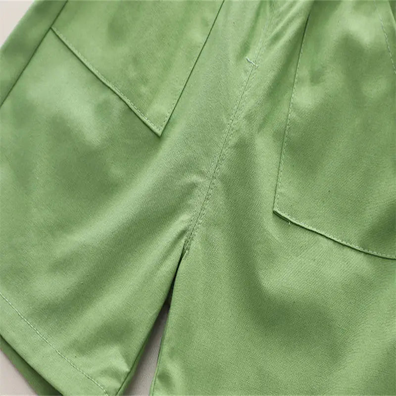 Two-piece boys' clothing set with vibrant dinosaur graphics, perfect for summer playtime