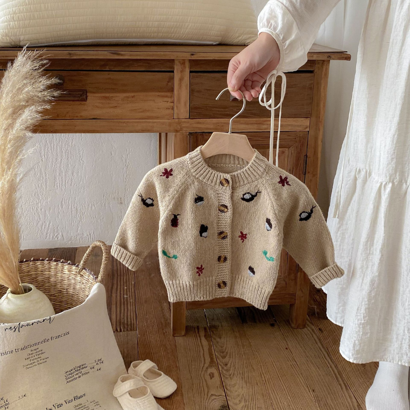 Playful cartoon design on a cozy girls' wool blend sweater, ideal toddler autumn wear