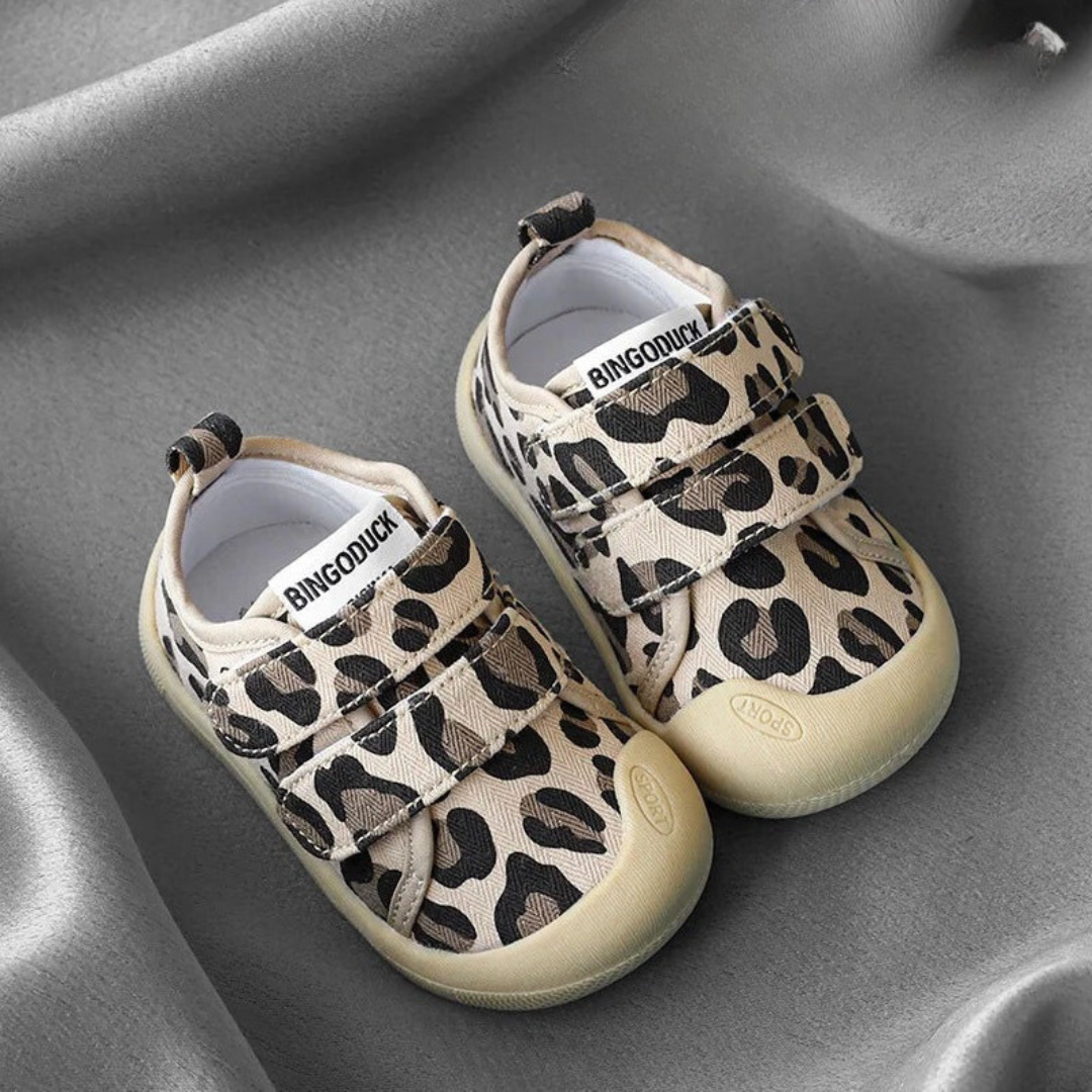 Packaging shot showcasing a pair of new breathable canvas sneakers for toddlers, ready for adventure.