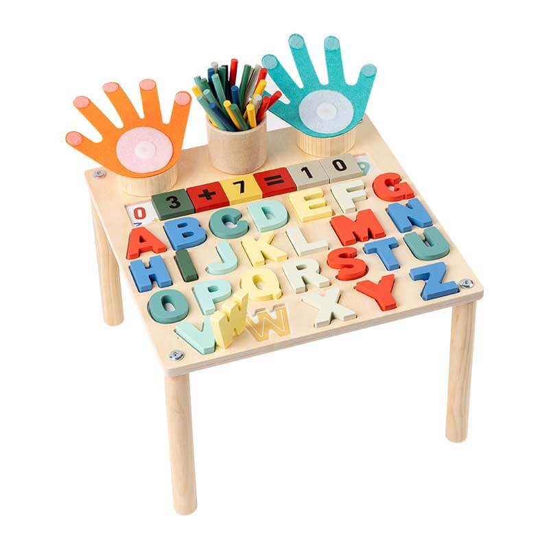Smiling child enjoying an educational game on a wooden interactive learning table, early education.