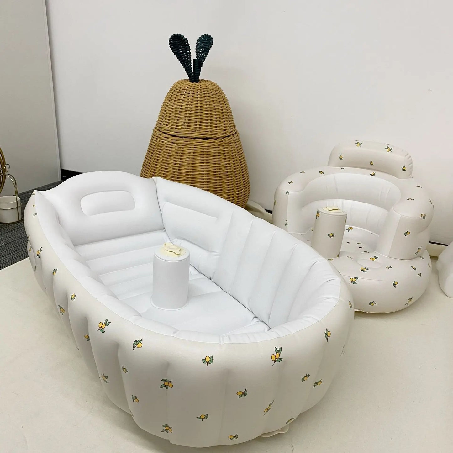 Child playing with bath toys in a large, portable inflatable baby bathtub, great for indoor/outdoor use