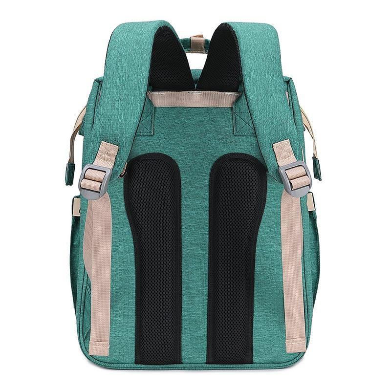 Diaper bag backpack converting into a portable crib, ideal for baby travel and nursery.