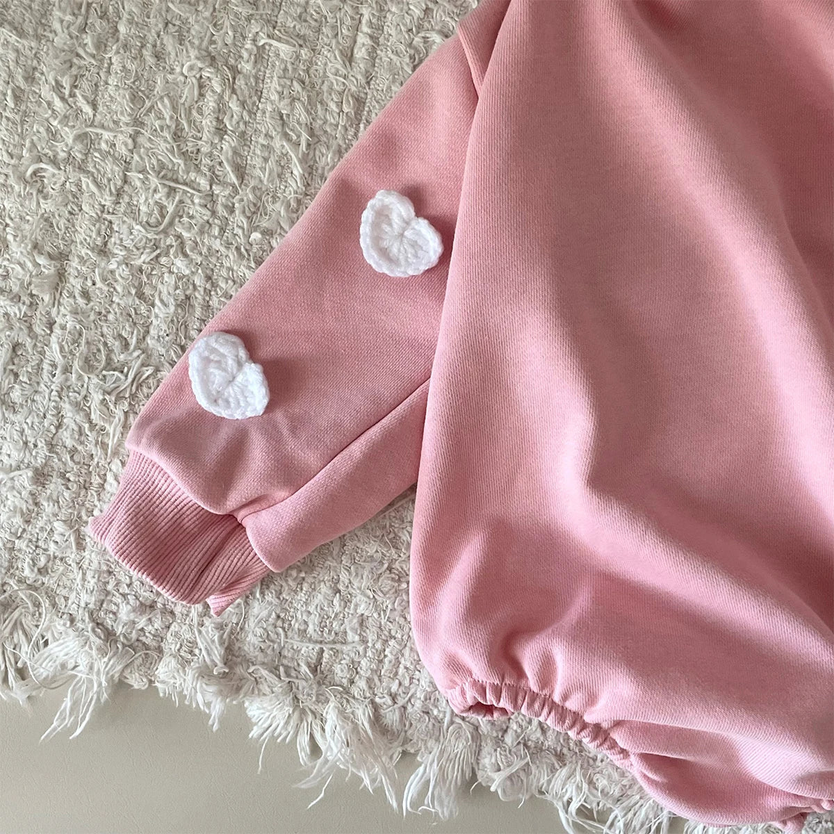 Delicate cloud print on a pure cotton baby romper, emphasizing softness and gentle design.