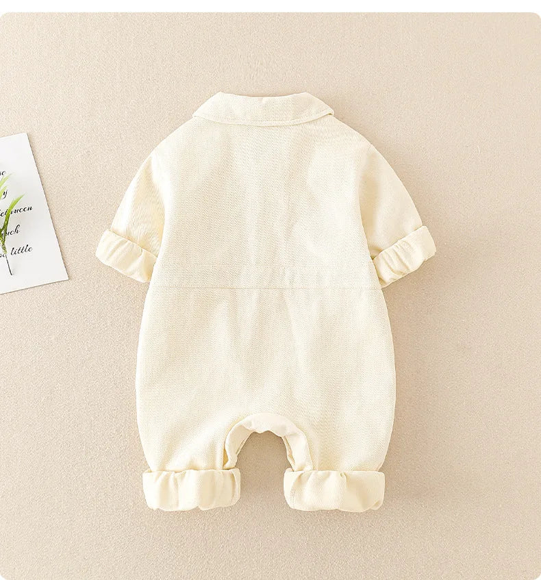 Happy child playing in a comfortable and durable denim jumpsuit, capturing the essence of kids' fashion and play.