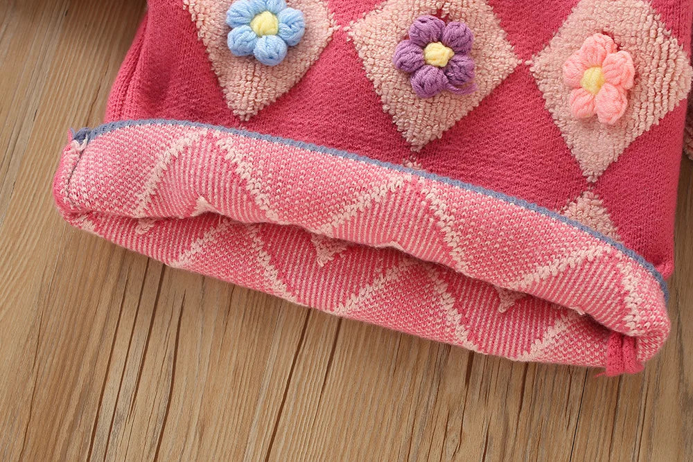 Detailed view of the girls' knitted set, showcasing the vintage design of the pullover and matching skirt.