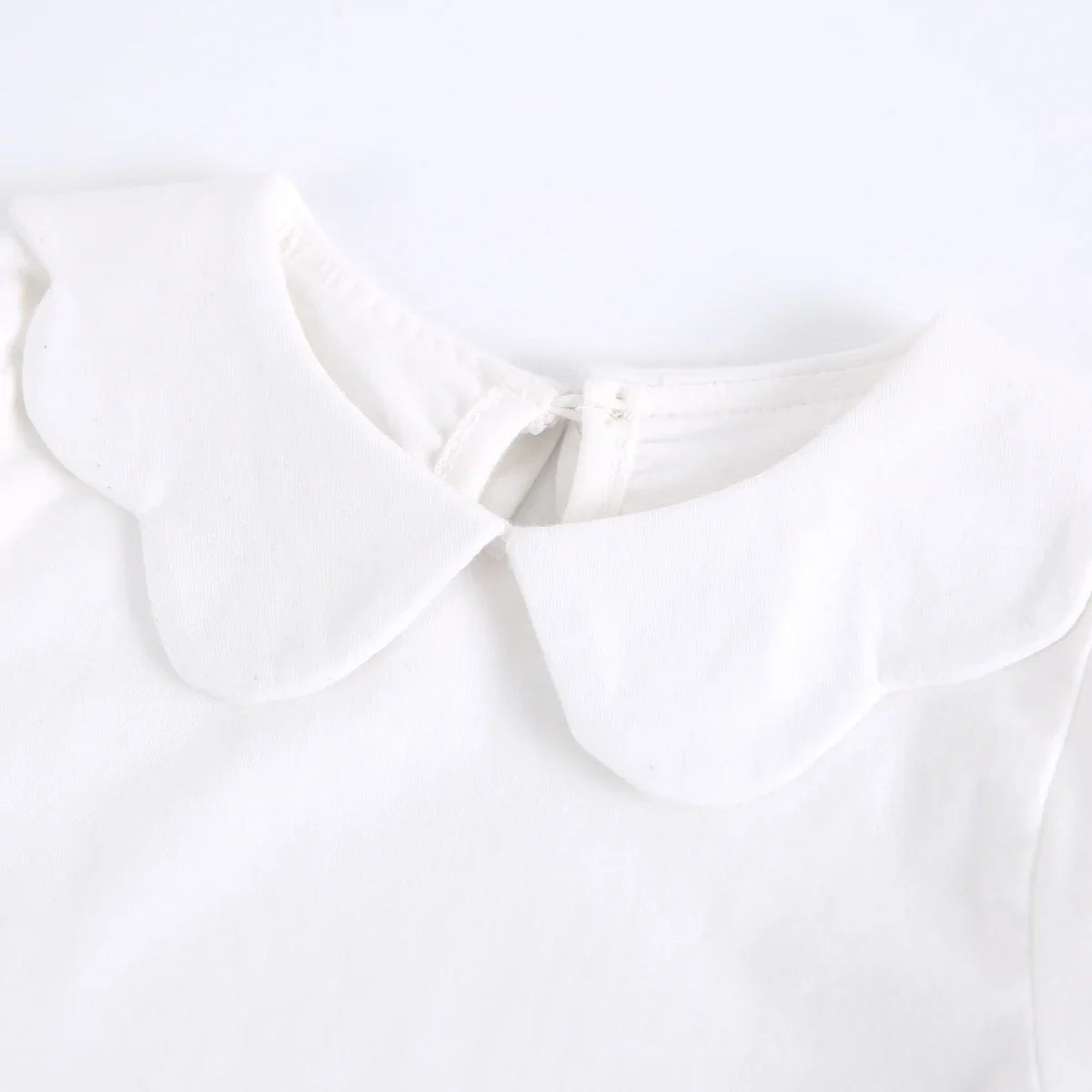 Toddler girl laughing in a comfortable white cotton short sleeve fashion top