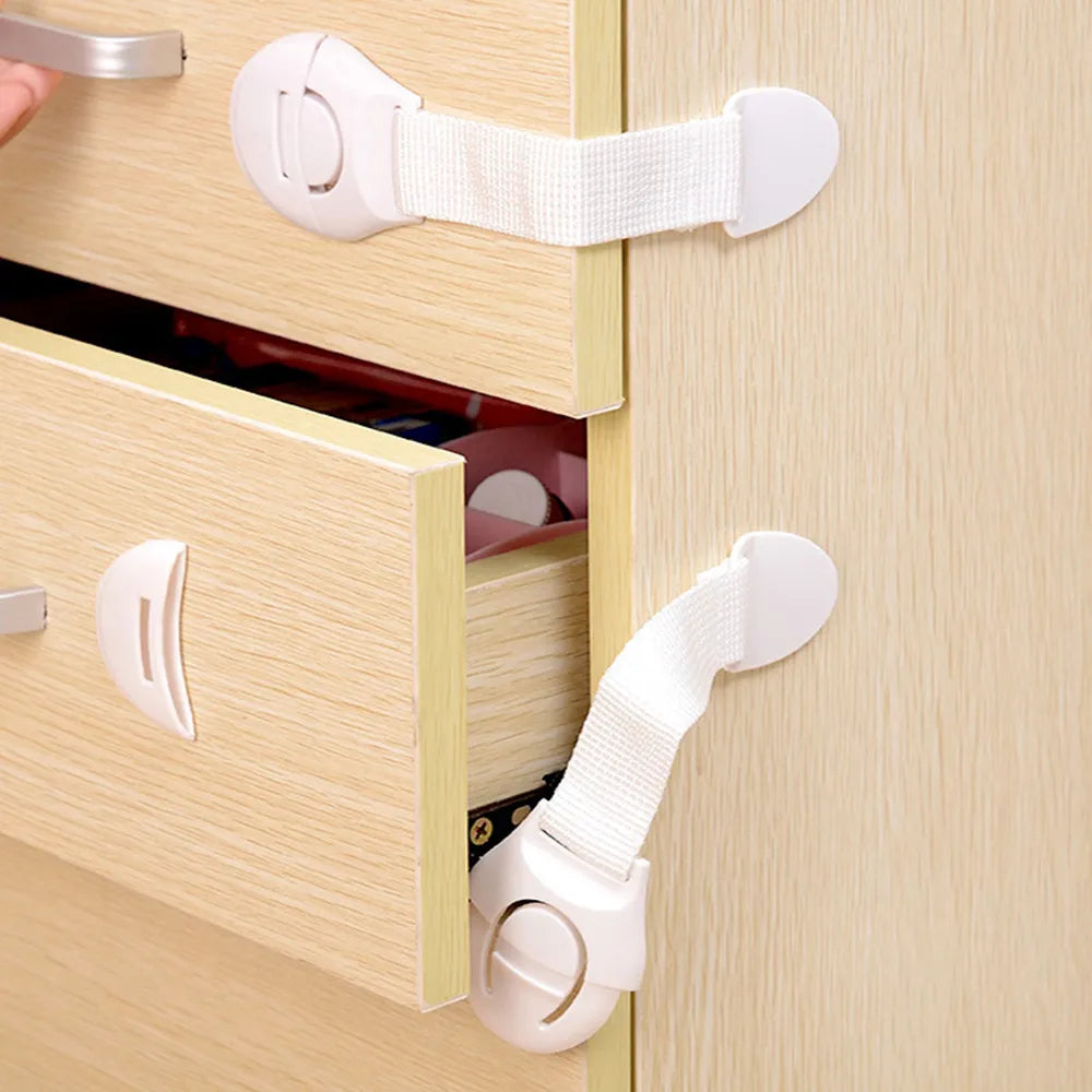 Close-up of child safety cabinet lock showing strong adhesive and latch mechanism