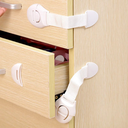 Close-up of child safety cabinet lock showing strong adhesive and latch mechanism
