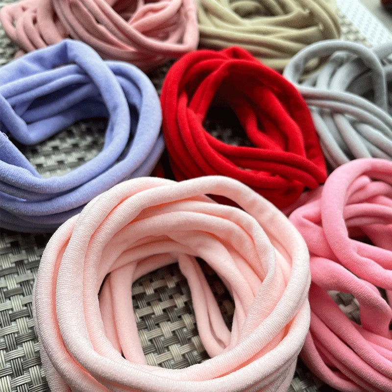 Girls' nylon headbands set in a row, featuring soft fabric for comfort